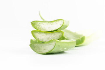 Fresh aloe vera leaves and slices isolate against white background for health and beauty products.