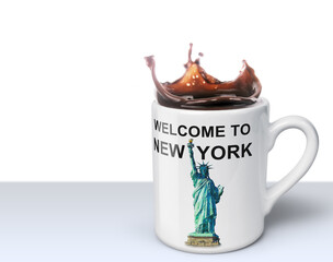 Welcome to New York - coffee mug with splashing coffee and illustration of Statue of Liberty isolated on white background with copy space