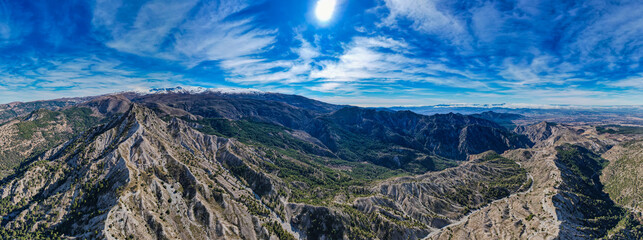 Aerial panoramic view of the mountains and valleys in the Sierra Nevada mountains in Spain - obrazy, fototapety, plakaty