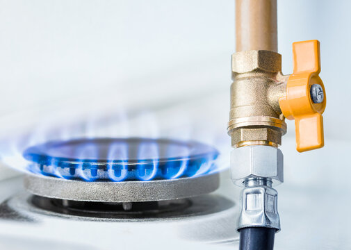 gas pipe with open yellow valve and burning gas burner, double exposure of natural gas use
