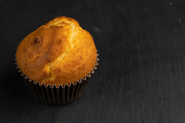 Soft and fresh fragrant wheat cupcake on a black stone