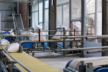 Factory workshop with bags on the conveyor line.