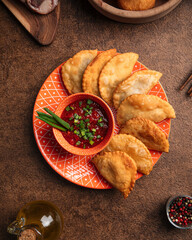 Portion of oriental meat stuffed pies chebureks with sauce