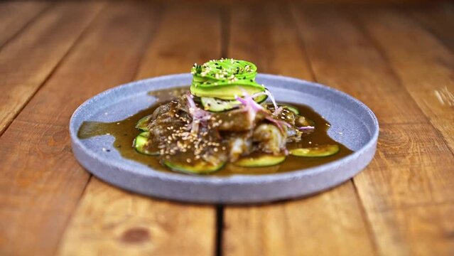 Aguachile plate, traditional Mexican dish on a wooden table.