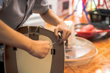 Close uo electronic man hands fixing fan in electronic repair shop, Hands Concept