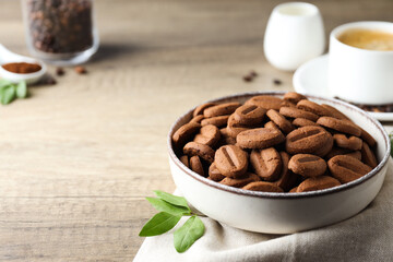 Concept of tasty snack for hot drink - cookies in the shape of coffee seeds