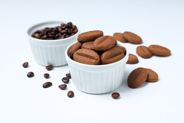 Concept of tasty snack for hot drink - cookies in the shape of coffee seeds