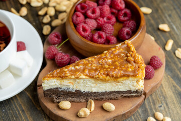 Cheesecake with chocolate sponge cake and peanuts in caramel