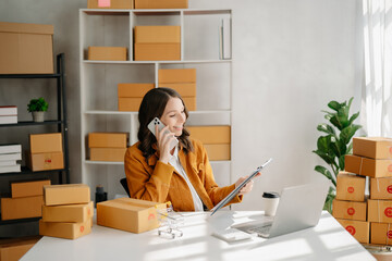 Fototapeta na wymiar Small business entrepreneur SME freelance woman working at office, BOX,tablet and laptop online, marketing, packaging, delivery, e-commerce concept..