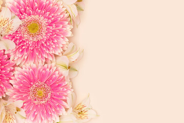 Gerbera and alstroemeria flowers on a beige background. Place for your design.