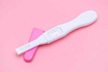 Opened pregnancy test isolated on the pink background.