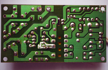 Electronic circuit board soldered face. Industrial electronics background.