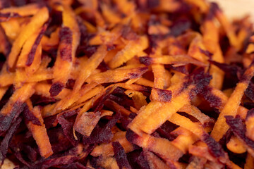 Finely grated red-orange carrots in the kitchen