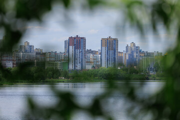Buildings and houses standing on the shore of a lake, river or sea.
Cityscape and urban scene.
