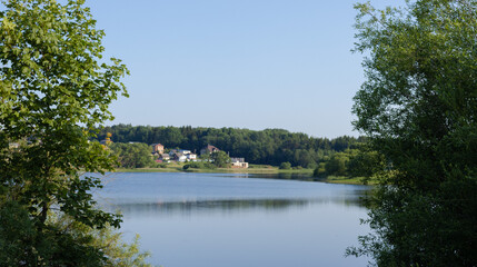Buildings and houses standing on the shore of a lake, river or sea.
Cityscape and urban scene.