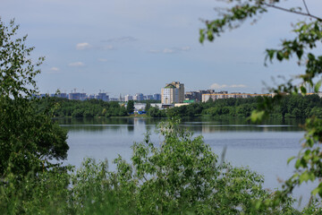 Obraz premium Buildings and houses standing on the shore of a lake, river or sea. Cityscape and urban scene.