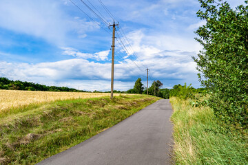 Obraz premium Beautiful empty asphalt road in countryside on colored background