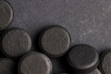 Open and unpacked tablets of black color close-up