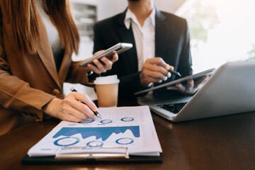 Business team meeting. professional investor working new start up project. Finance task. with smart phone and laptop and digital tablet computer  in morning light..