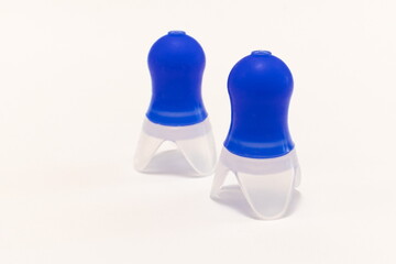 Silicone ear plugs for human ears on white background