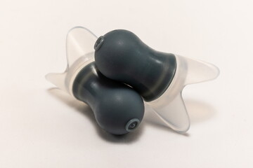 Silicone ear plugs for human ears on white background