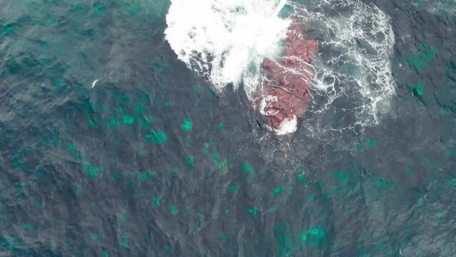 Overhead view of turquoise and black water in the Indian ocean near the Pont Naturel