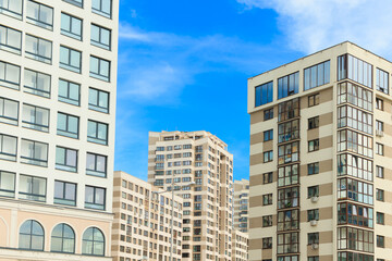 Fototapeta na wymiar City view on a sunny day. Modern houses against the blue sky.