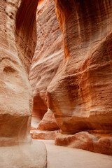 Jordan. Peter. Canyon Siq or El Siq. Sheer cliffs of a canyon or rocky cleft, 92 to 182 meters high, hang over narrow path. Only road to rock city of Nabatean kingdom, to ancient city of Petra.