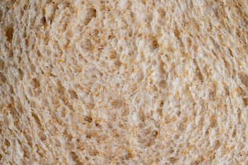 Square loaf of light wheat bread cut into pieces