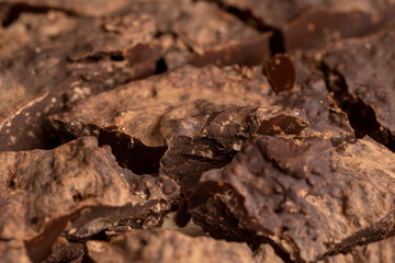 Pieces of chocolate with added cocoa and sugar