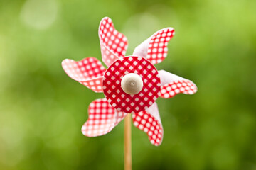 Playful Red White Pinwheel Across Green Grass - 576631452