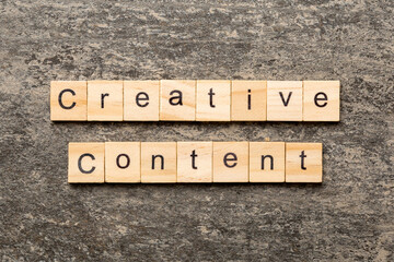 creative content word written on wood block. creative content text on table, concept