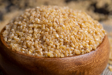 Fresh wheat porridge in a wooden bowl