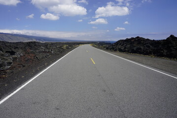 Asphalt road going throw lava field in Volcanoes  National park in Big Island in Hawaii