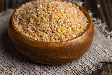 Fresh wheat porridge in a wooden bowl