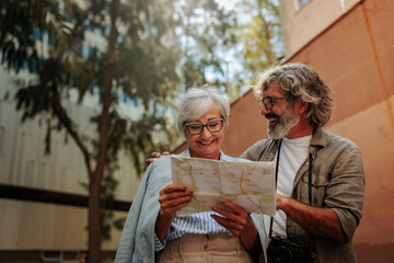 Cheerful senior tourists using map.