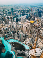 Aerial view of Downtown Dubai with roads, Dubai Mall and the fountain at sunrise, from Burj Khalifa...