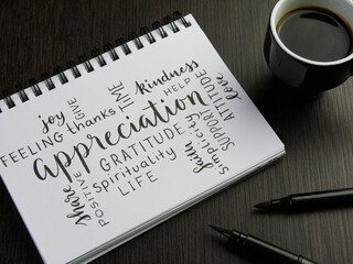 APPRECIATION handwritten word cloud in notebook with cup of espresso and pens on black wooden desk - obrazy, fototapety, plakaty
