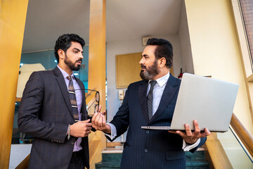 Indian senior businessman angry on his manager after looking in laptop