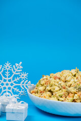 Olivier Russian salad, Christmas and New Year food, blue background.