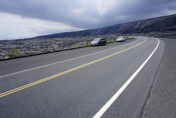 Asphalt road going throw lava field in Volcanoes  National park in Big Island in Hawaii