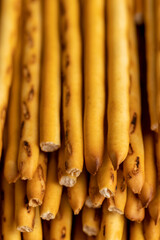 Thin and long bread sticks made of wheat flour on the table