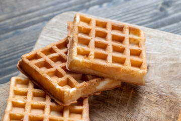 Soft fresh waffles with bee honey close-up