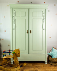 Decorated wardrobe after renovation in mint color