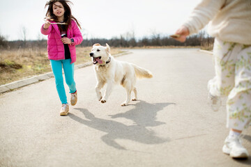 Kids running with the dog