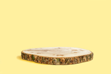 Wooden Podium with Bark. Real Wood Slab. Empty Round Natural Form. Pedestal for Showing Product, Eco Organic Cosmetic, Jewelry. Trendy Minimal Style Mock Up Presentation. Yellow Studio Background. 3d