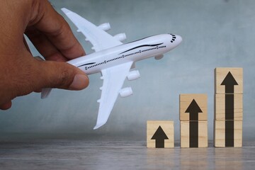 Top view image of toy plane and upward arrow. Business transportation industry with increase profits and growth,