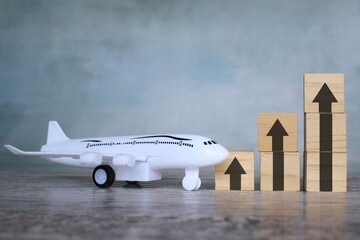 Top view image of toy plane and upward arrow. Business transportation industry with increase profits and growth,