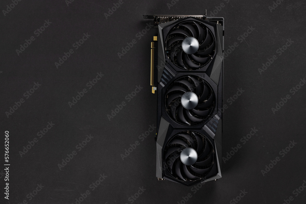 Poster large and powerful graphics card with three fans on dark background top view