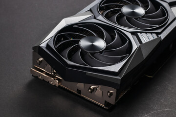 A close up of a modern GPU Graphic card on dark background.